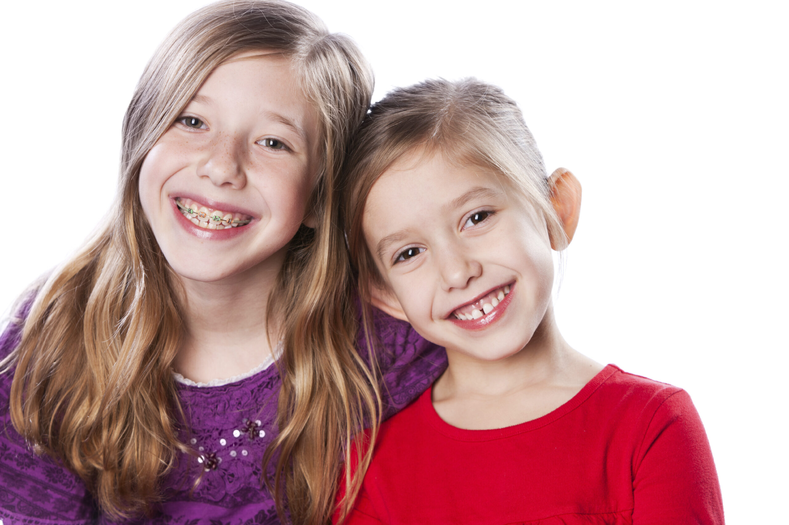 Two smiling girls displaying healthy, bright smiles for a Corpus Christi dental practice.
