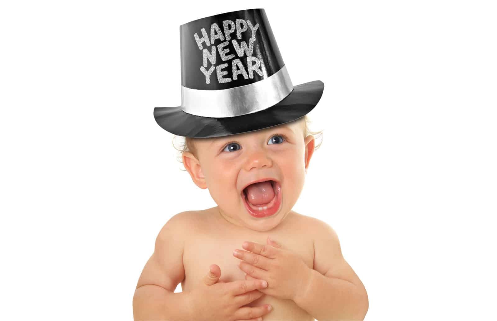 Happy baby celebrating the new year with a festive party hat and joyful smile.
