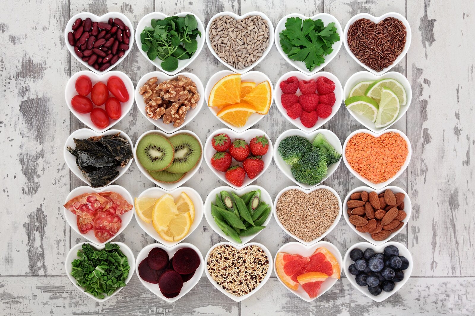 Healthy foods in heart-shaped bowls for National Nutrition Month at Corpus Christi dental practice.