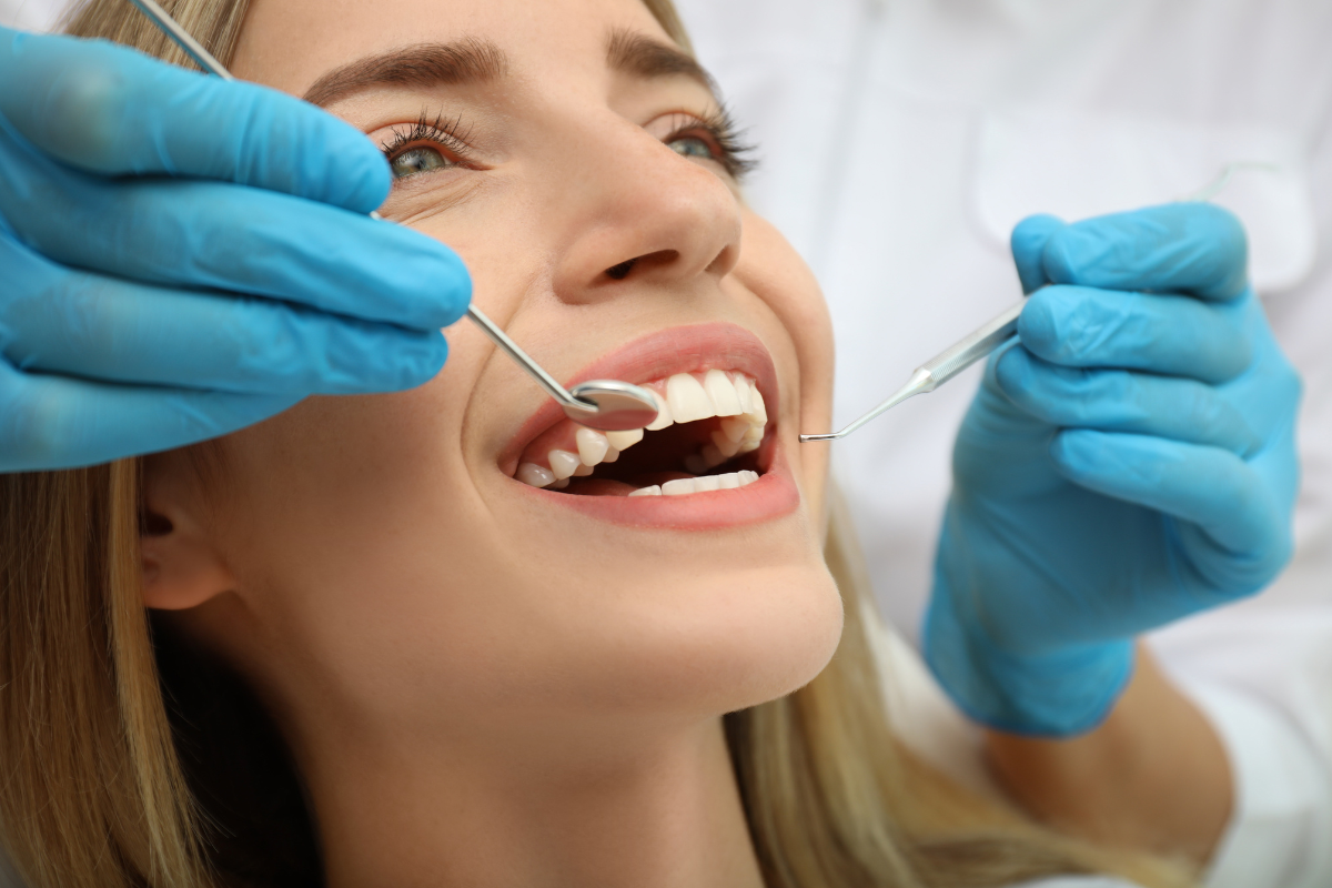 Dentist examining patient's teeth during cosmetic dental consultation in Corpus Christi.