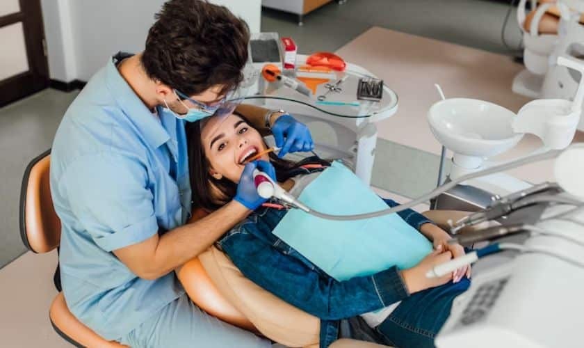 Dentist examining patient's teeth during dental implant consultation in Corpus Christi.