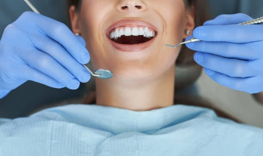 Dentist examining patient's teeth during oral cancer screening in Corpus Christi.