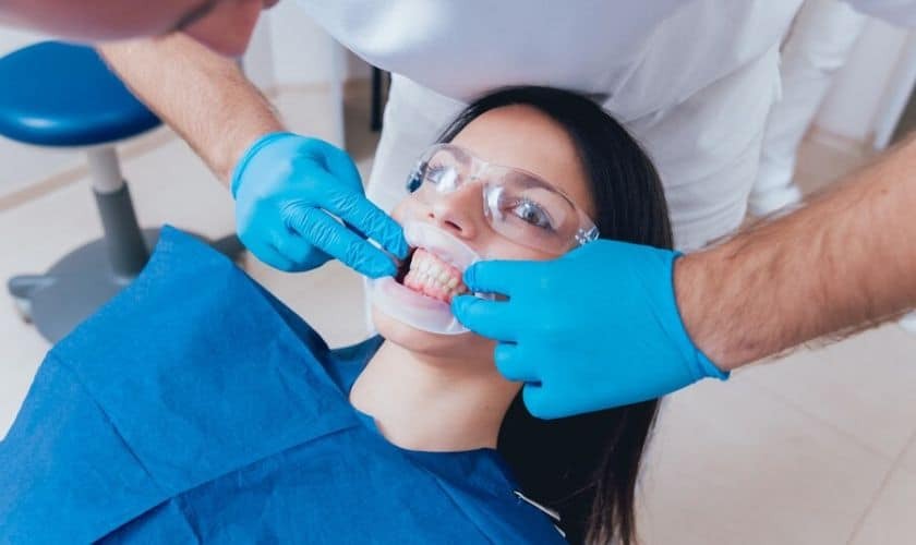 Dentist examining patient's teeth during cosmetic dental treatment in Corpus Christi.