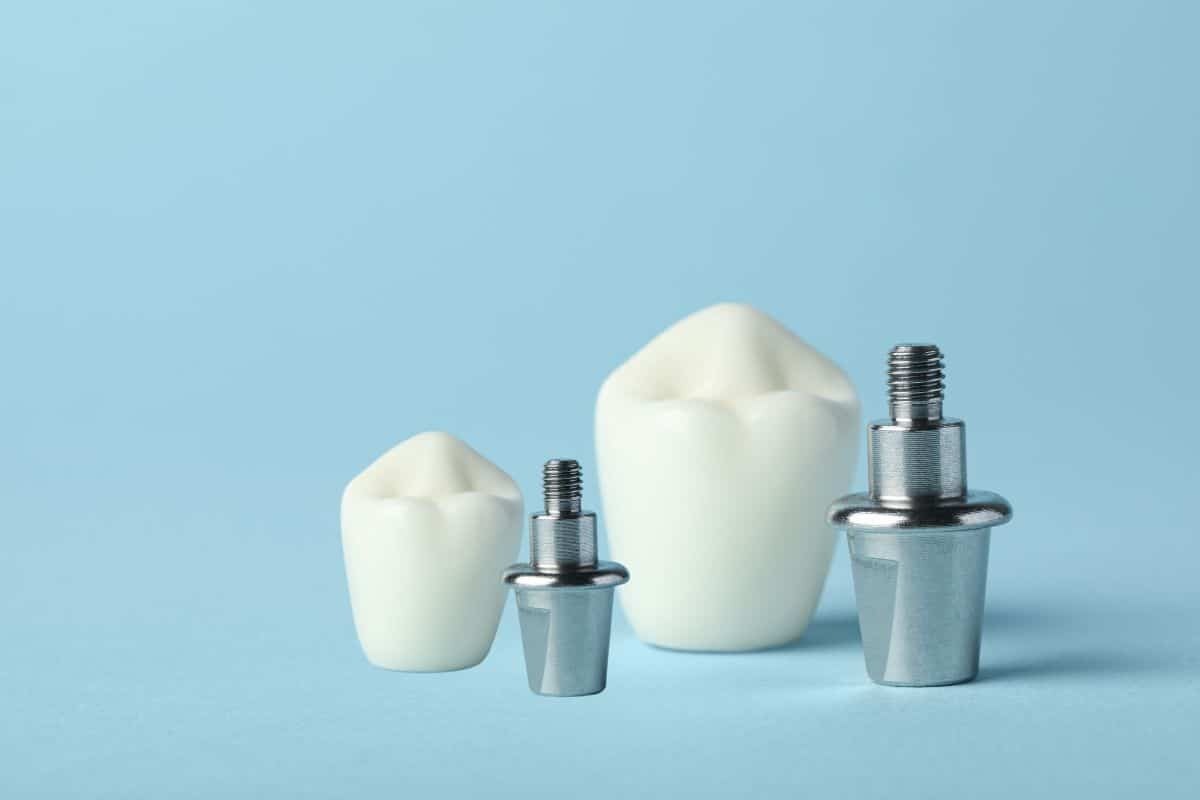 Two dental implant components shown in different sizes against a blue background.