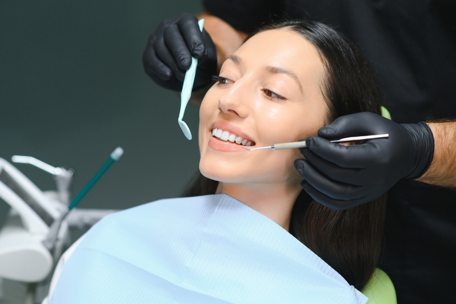 Dentist examining patient's teeth during cosmetic dental treatment in Corpus Christi.