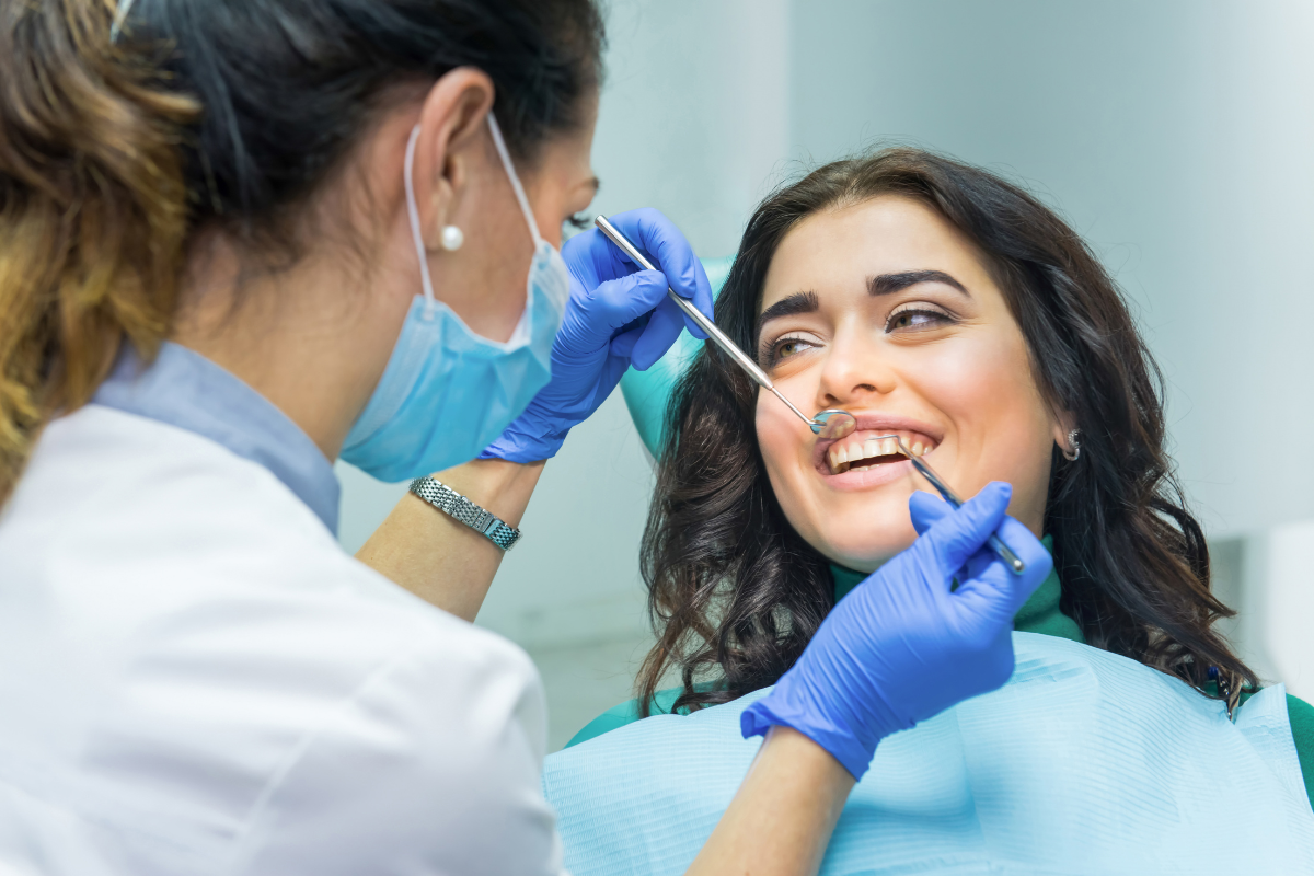Dentist examining patient's teeth during dental checkup and treatment.