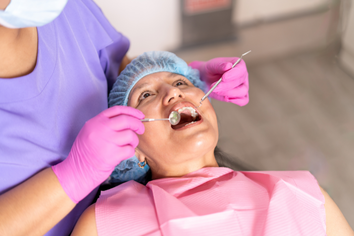 Dentist examining patient's teeth during routine checkup to identify hidden dental problems.